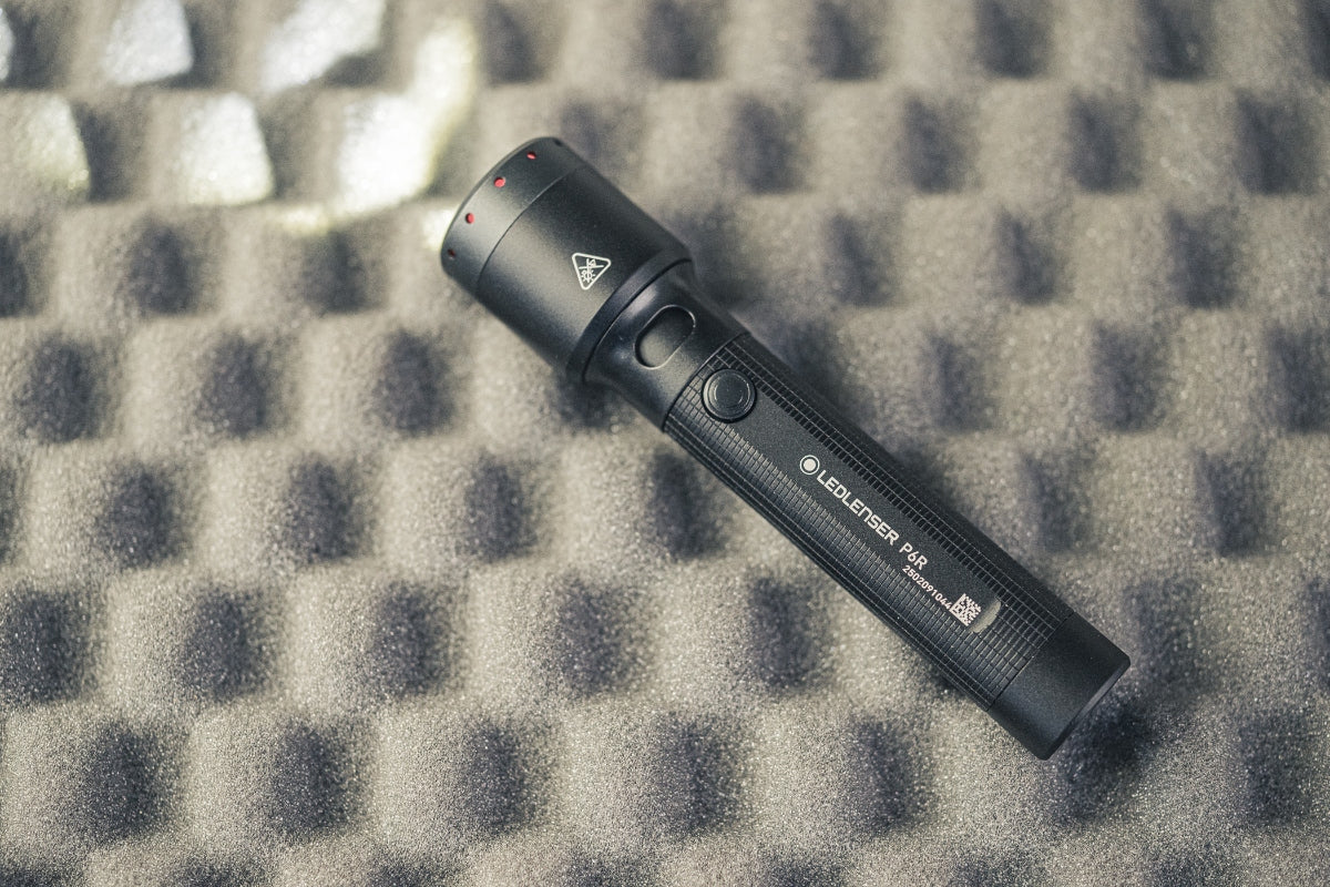 Ledlenser P6R Torch black with textured grip shown diagonally on foam background handheld rechargeable flashlight