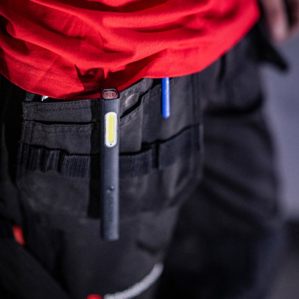 Ledlenser W2 Work Pen and Test Light clipped to a belt showing a slim pen‑style body with yellow LED panel