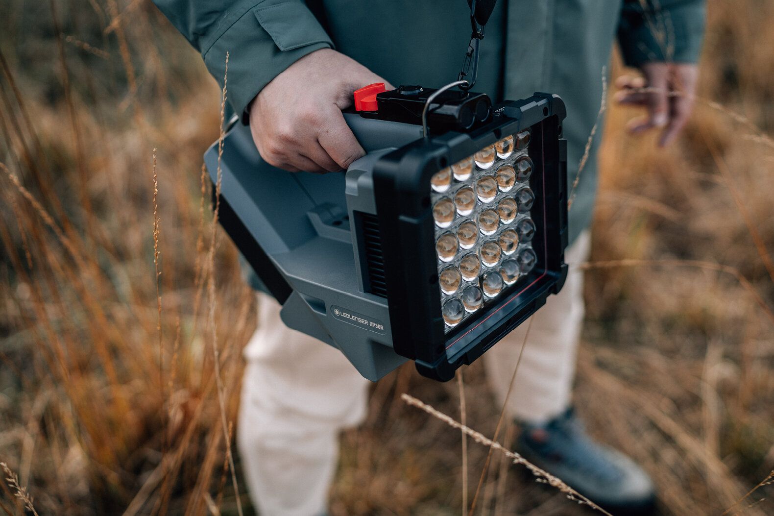 Ledlenser XP30R Spotlight portable floodlight carried outdoors featuring a multi LED array and rugged housing