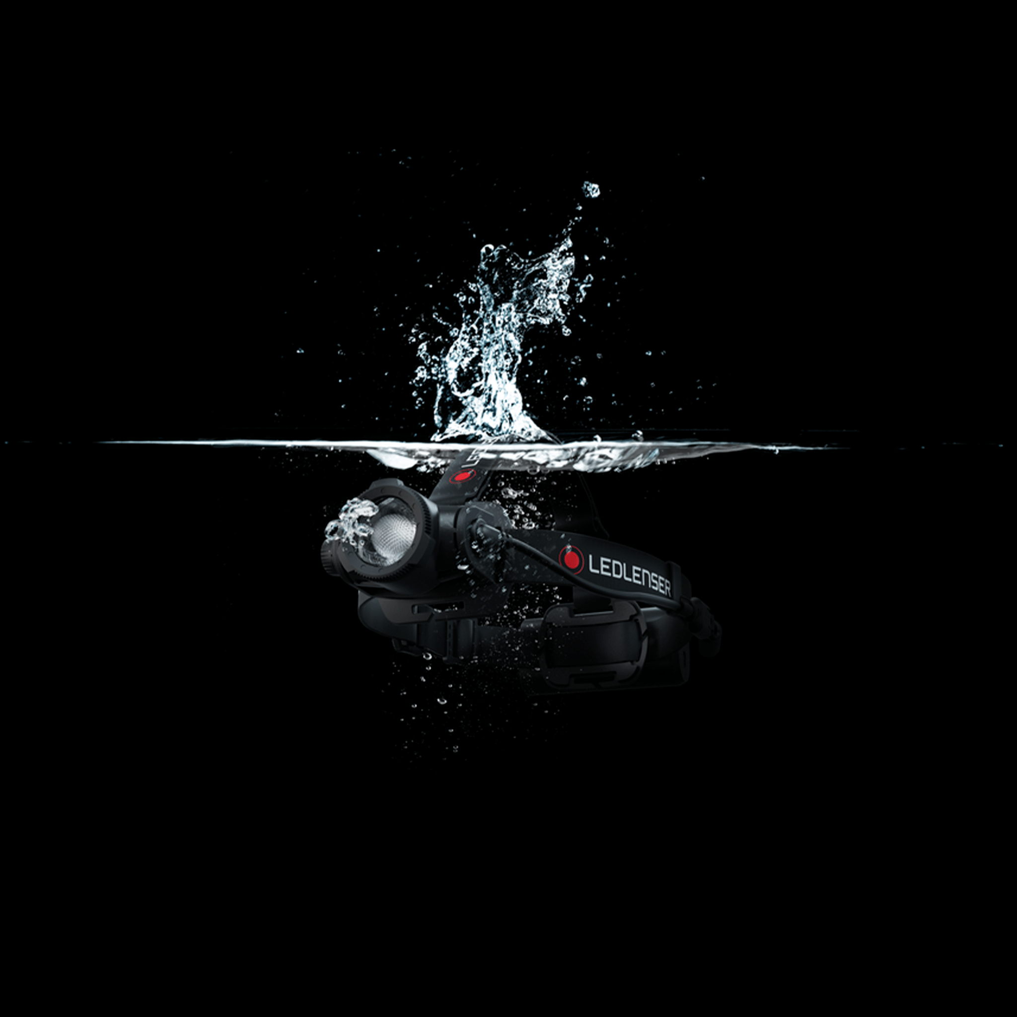 Ledlenser H15R Core Headlamp submerged in water with splash worn on a black headband