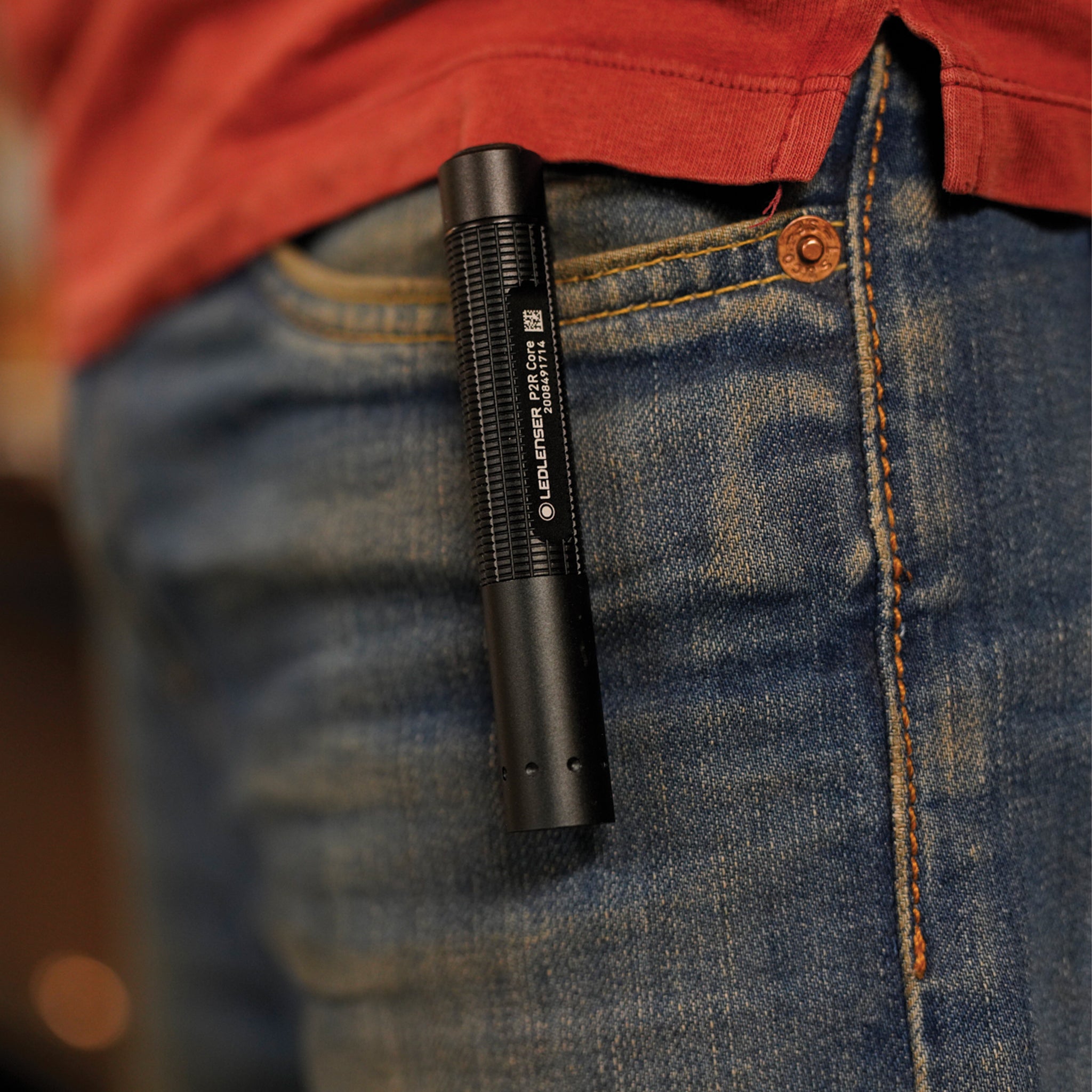 P2R Core Torch clipped in a denim jeans pocket black compact rechargeable torch worn in front pocket