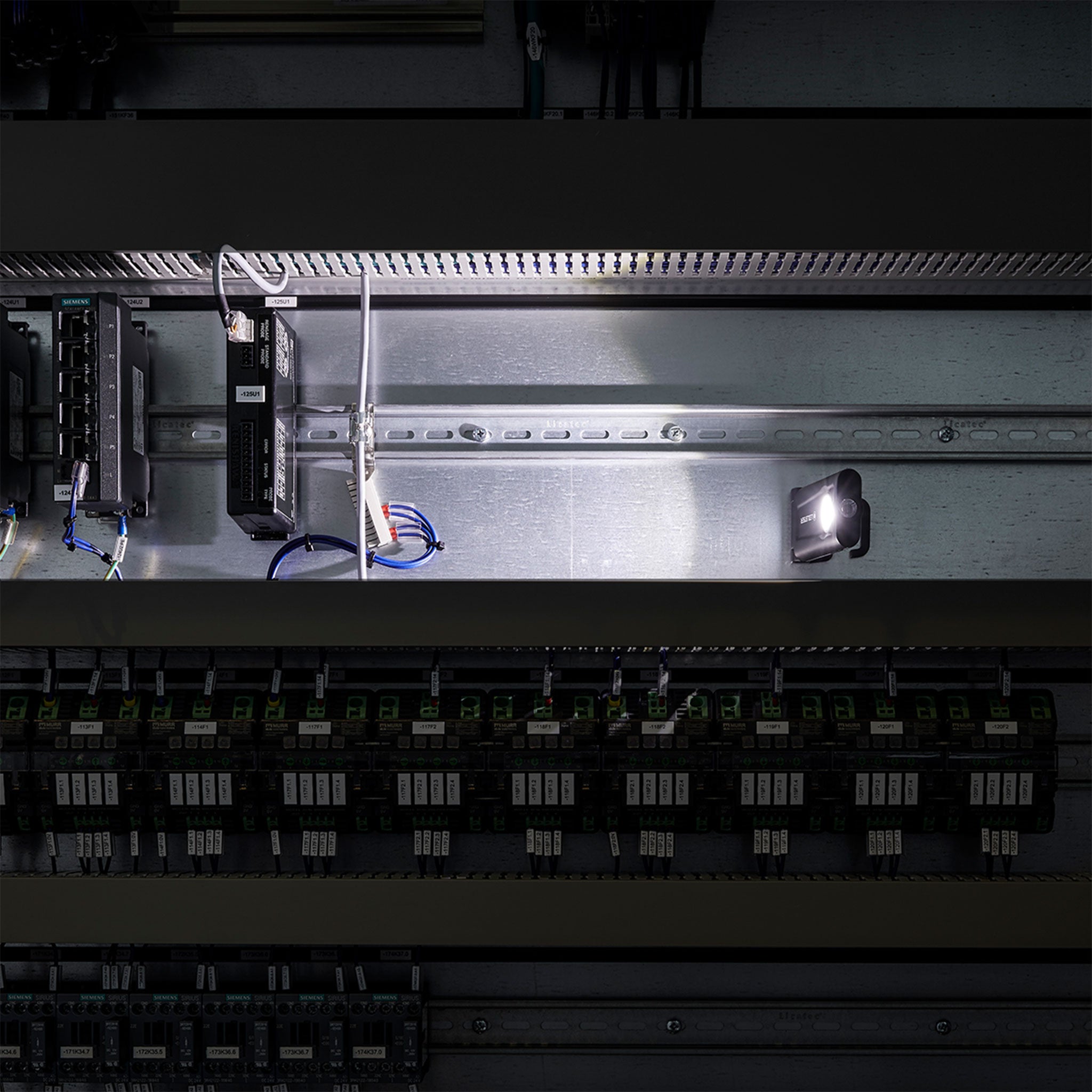 Ledlenser iF2R Spotlight mounted inside an electrical control panel with wiring and circuit modules