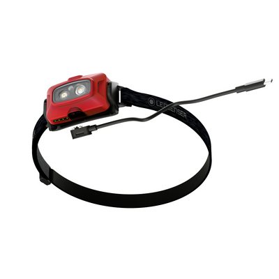 Ledlenser HF4R Core Headlamp mounted on black headband with red housing and dual LEDs USB charging cable trailing