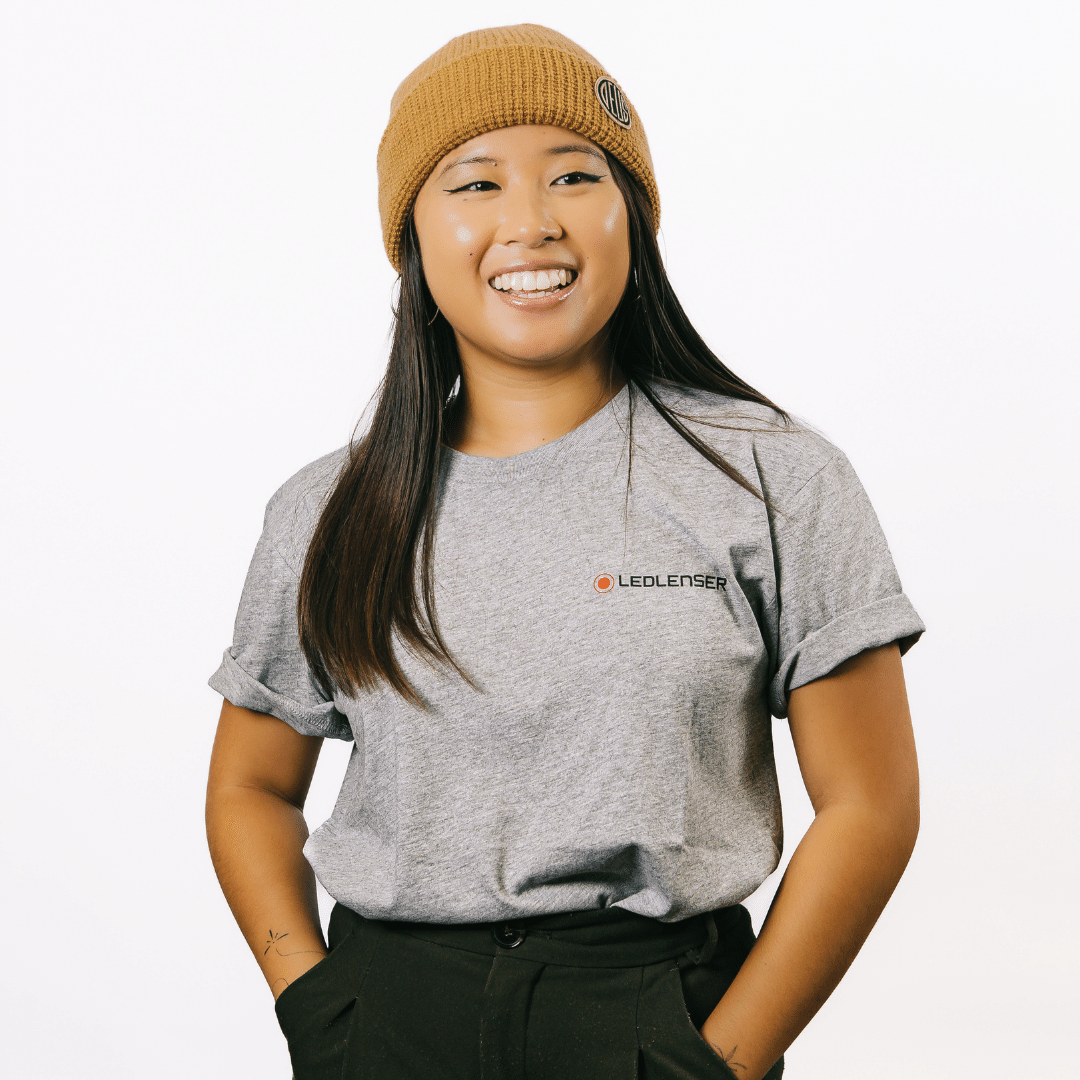 Mulga x Ledlenser Unisex Tee worn by a model showcasing a grey t shirt with the Ledlenser logo on the chest and a mustard beanie