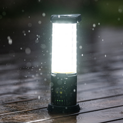 AL10R Work Lantern upright on a wet wooden surface with rain droplets bright light dark green base with control panel visible