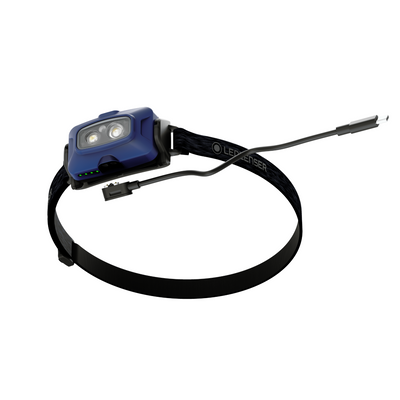 HF4R Core Headlamp by Ledlenser with blue body dual LEDs and adjustable head strap connected to charging cable