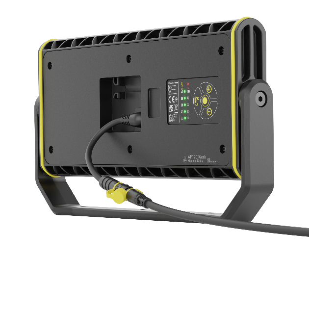 AF12C Work Floodlight seen from rear with power cable plugged in black housing with yellow accents and integrated stand