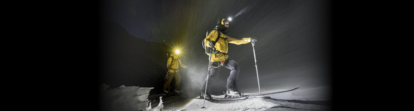 Two men in heavy snow using Ledlenser Headlamp