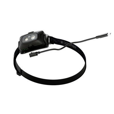 HF4R Core Headlamp with dual LEDs black strap battery indicators and charging cable with USB C plug visible