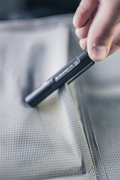 Ledlenser P2R Torch held in a hand close up of the black textured body and model label on the side