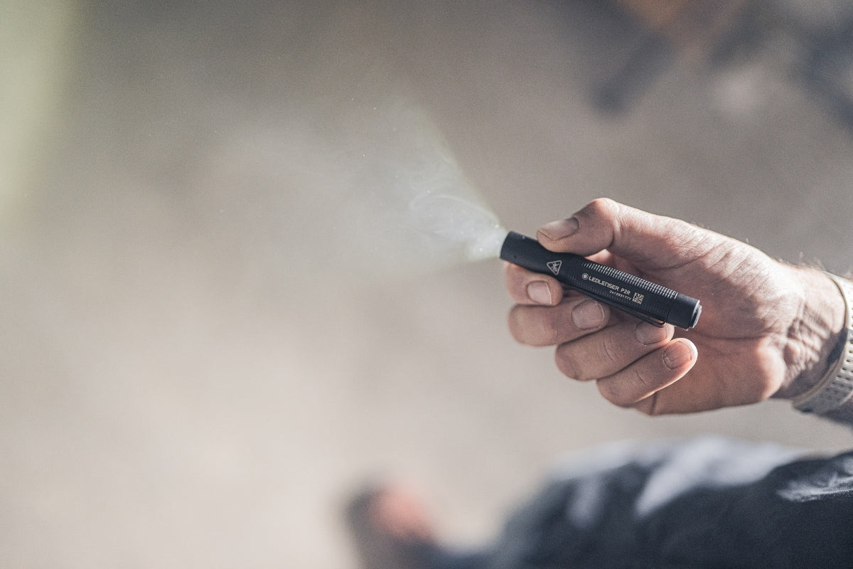 Ledlenser P2R Torch handheld compact torch held in a right hand with light emitted