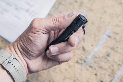 P3 Torch held in a hand compact black Ledlenser pocket flashlight with keyring attachment