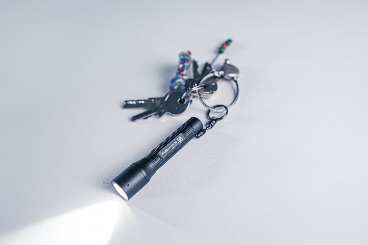 Ledlenser P3 Torch compact black flashlight on a keychain with multiple keys beam illuminated