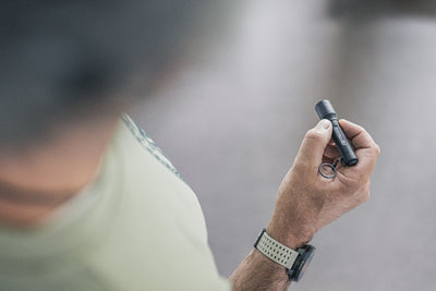 Ledlenser P3 Torch held in hand a compact key flashlight with a key ring grey black finish wearer’s wristwatch visible