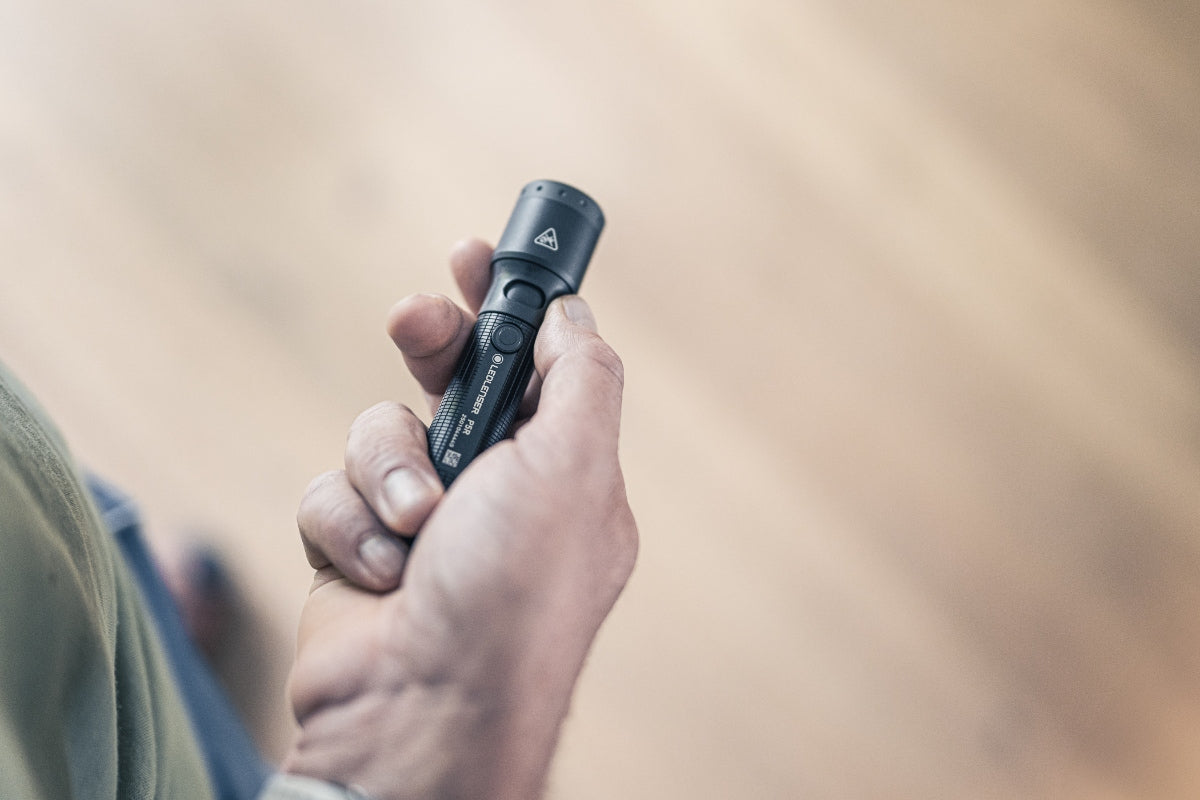 P5R Torch held in a hand close up of a compact Ledlenser rechargeable flashlight