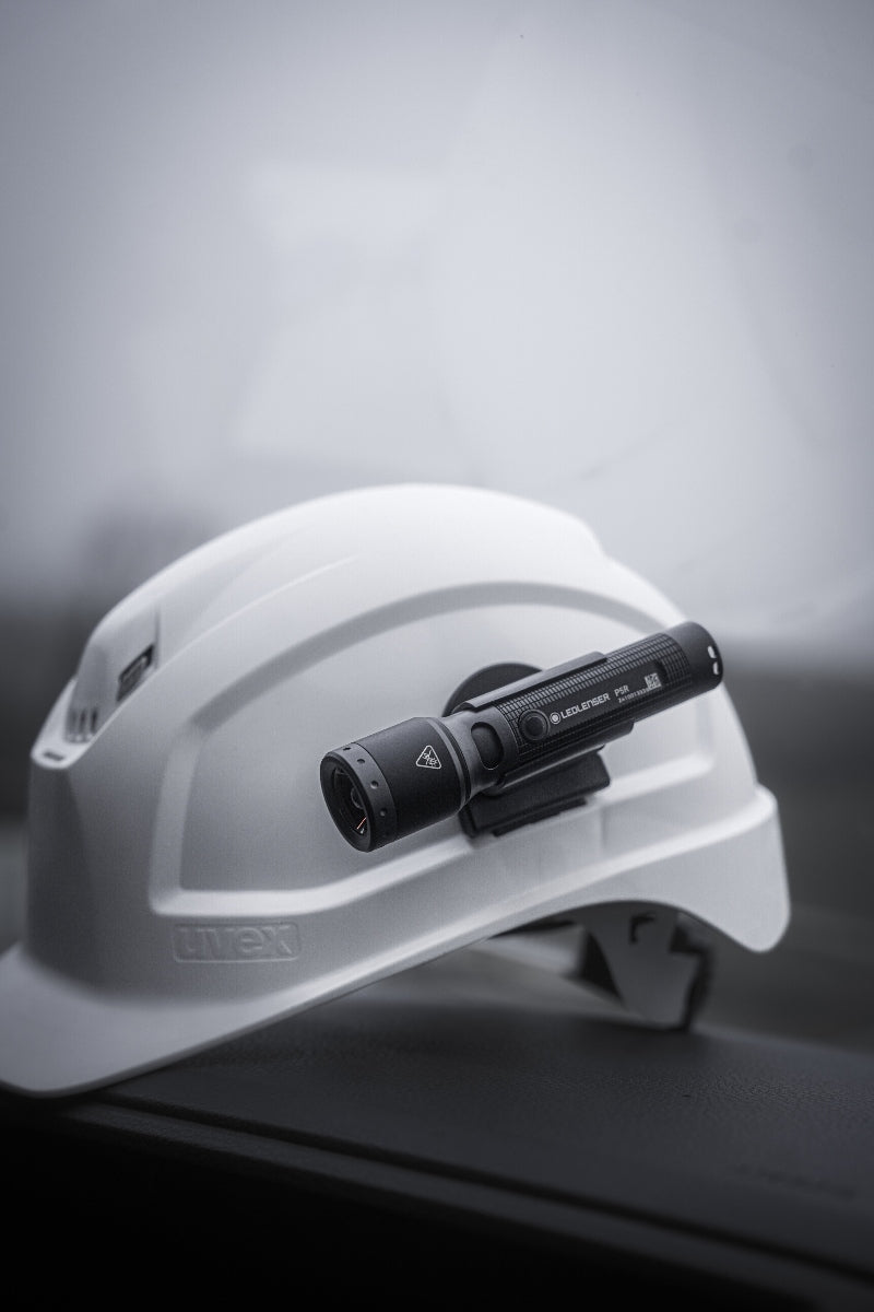 Ledlenser P5R Torch mounted on a white safety helmet close‑up side view of the compact flashlight for professional use