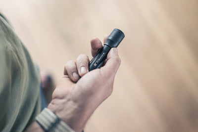P5 Torch held in a hand; compact black Ledlenser flashlight with a textured grip and cylindrical body