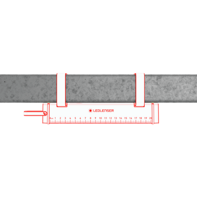 AF2R Work Area Light by Ledlenser red and white compact light mounted under a metal beam with a ruler for scale