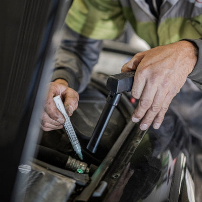 Ledlenser W7R Work Light being used by a technician on a car engine bay handheld portable work light