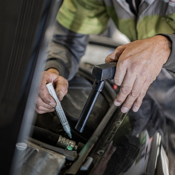 Ledlenser W7R Work Light being used by a technician on a car engine bay handheld portable work light