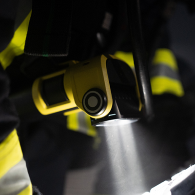 Ledlenser EXC6R Light compact rechargeable right angle torch yellow body beam projecting downward while mounted on gear