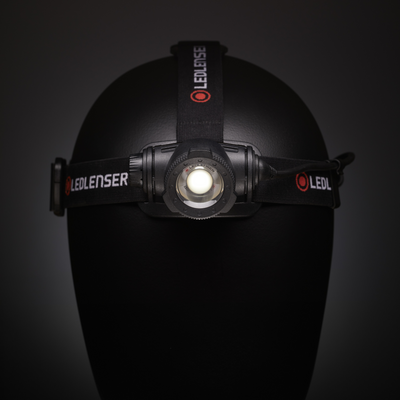 Ledlenser H7R Core Headlamp mounted on a black branded headband displayed on a mannequin head with central LED module visible
