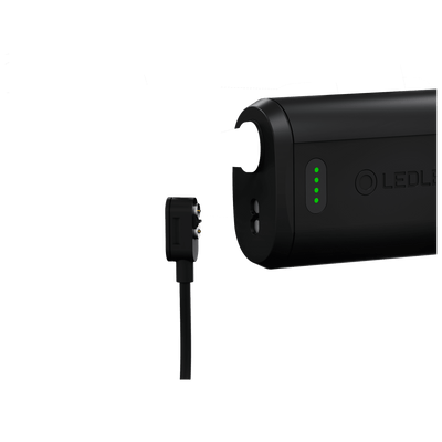 Ledlenser H19R Core Headlamp charging interface with battery pack and plug showing green indicator lights