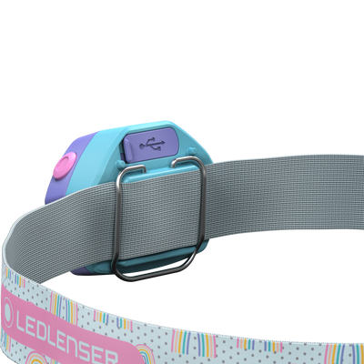 Kidled4R Headlamp by Ledlenser children's headlamp with blue teal body and pink button mounted on a grey elastic head strap