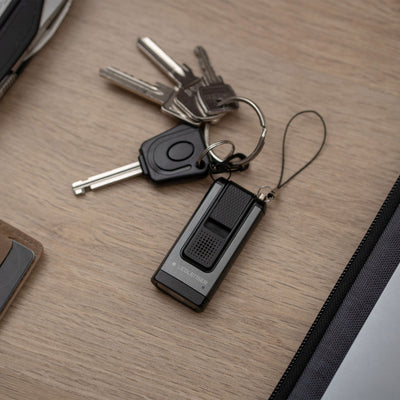 K6R Safety Keychain Light by Ledlenser compact black keychain light with attached lanyard and keys on a wooden surface