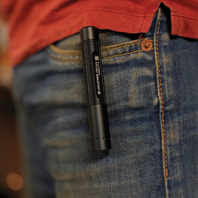 P2R Core Torch clipped in a denim jeans pocket black compact rechargeable torch worn in front pocket