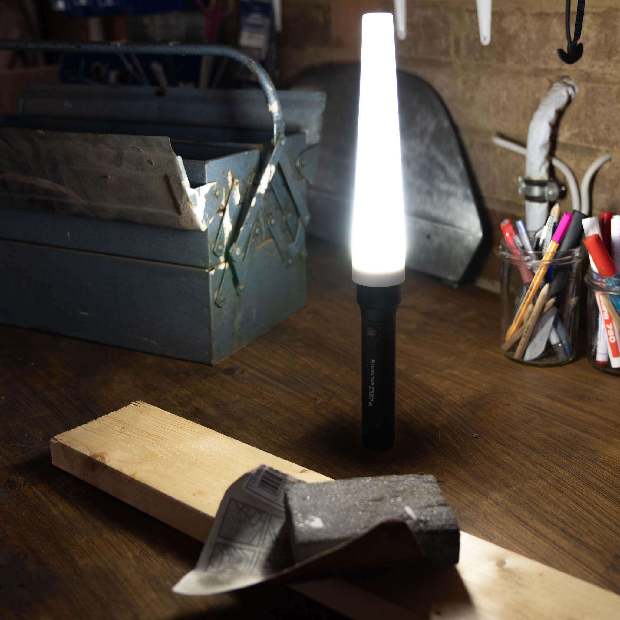 Ledlenser Signal Cone W 53mm attached to a P17R Core torch illuminating a workshop desk