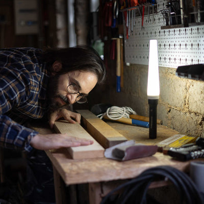 Signal Cone W 53mm Suits P17R Core Torch accessory shown beside a bright Ledlenser lamp as a craftsman works on wood