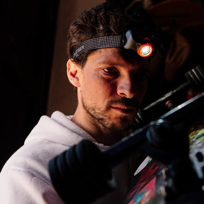 Ledlenser MH7 Powercase Combo headlamp worn on a man’s head in low light with charging case visible