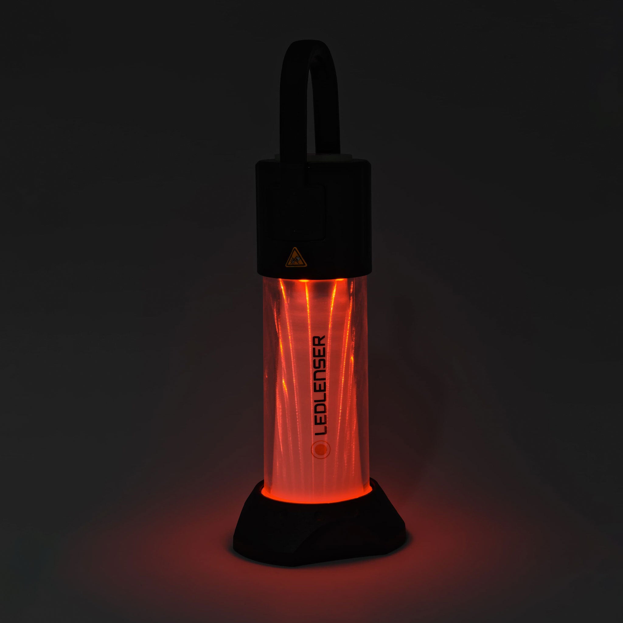 ML6 Lantern shown upright with a top handle red illuminated translucent body and Ledlenser branding