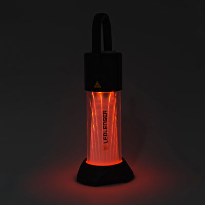 ML6 Lantern shown upright with a top handle red illuminated translucent body and Ledlenser branding