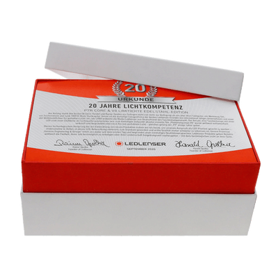 P7R Core Rechargeable Torch & V8 Keychain Light Limited Stainless Steel Edition packaging featuring a red certificate card with 20 Jahre Lichtkompetenz
