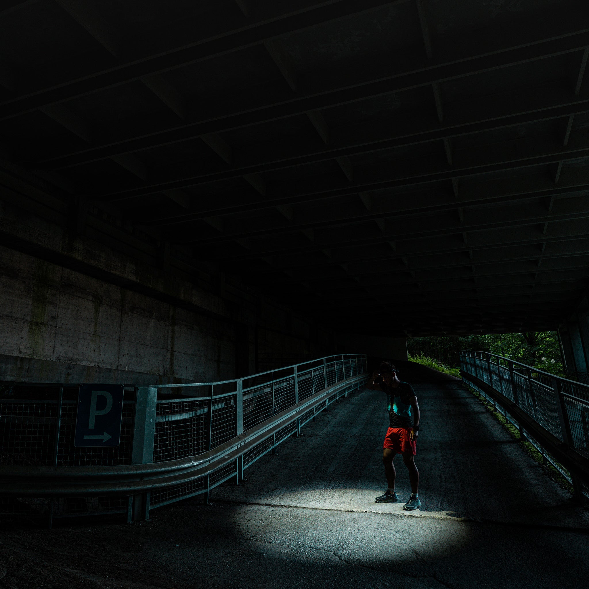 Ledlenser P7R Signature torch illuminating a dark underpass with a person standing in the light beam
