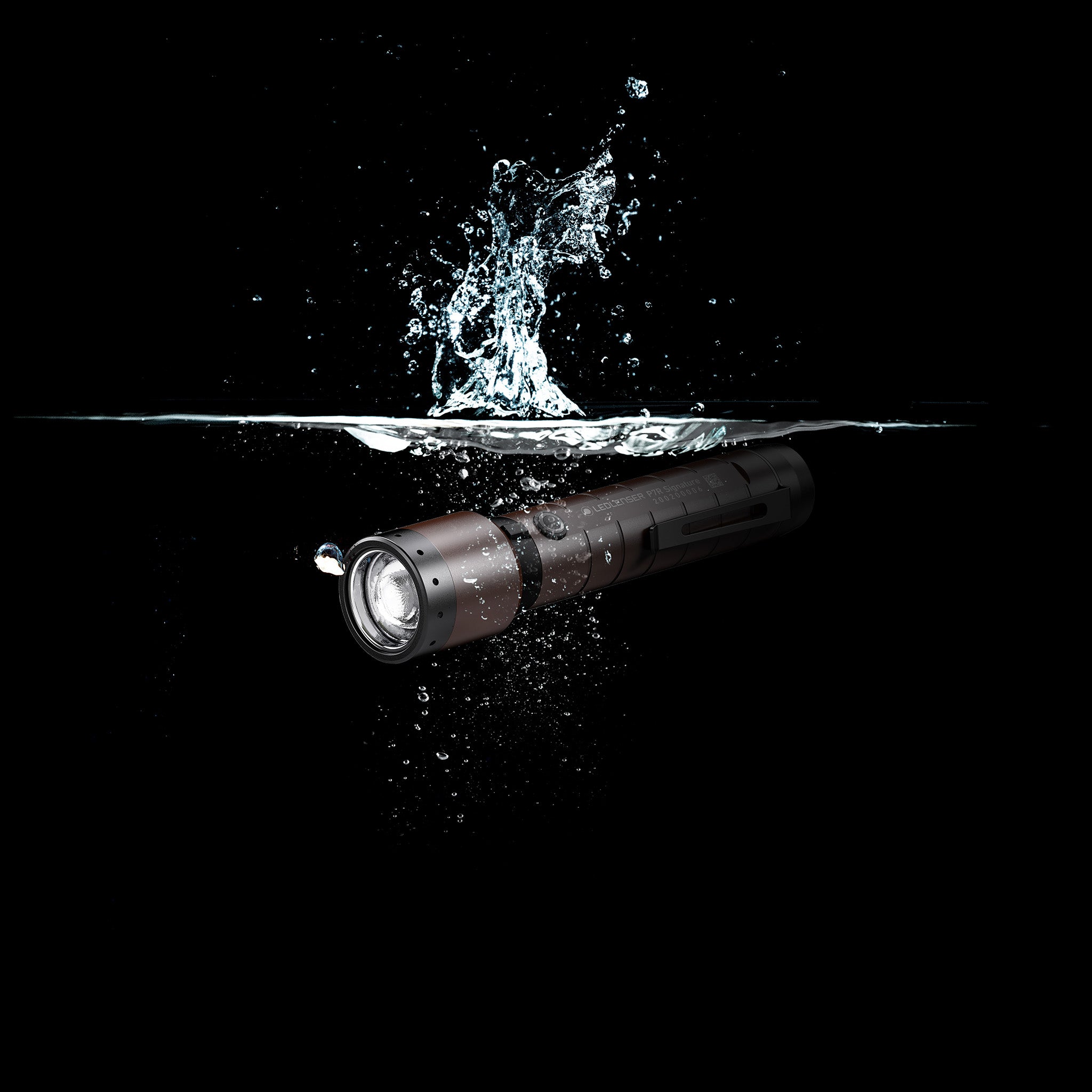 Ledlenser P7R Signature Torch submerged in water horizontal orientation black with brown accents