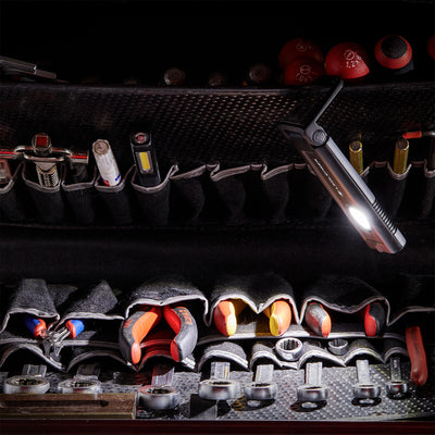 iF2R Spotlight compact rechargeable floodlight in a black tool roll with wrenches and sockets; light on