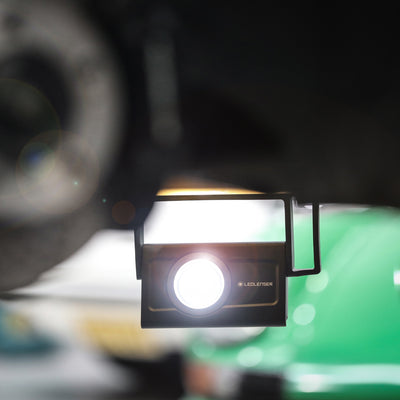 Ledlenser iF4R Spotlight mounted on a frame with its front lens illuminated showcasing compact professional lighting in use context