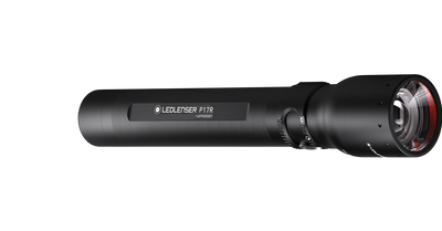 Ledlenser P17R rechargeable torch laid horizontally black metal body with textured grip and front lens with red bezel